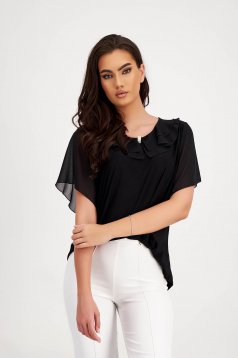 Black cotton women's blouse with a wide cut and ruffles along the neckline, accessorized with a brooch