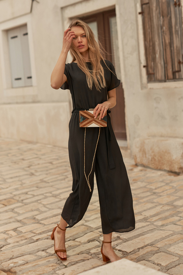Black jumpsuit thin fabric long flared with elastic waist accessorized with tied waistband